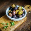 Olives on rustic wooden background